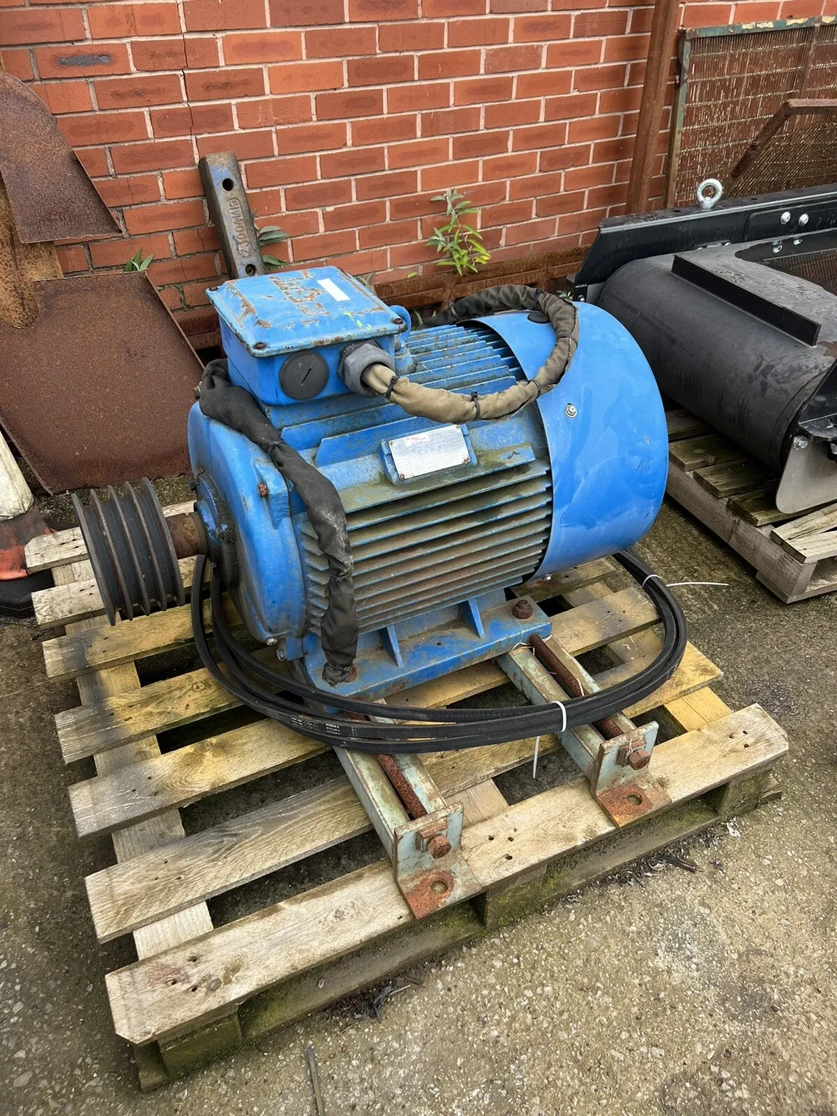 Used electric motor with drive pulley on a pallet